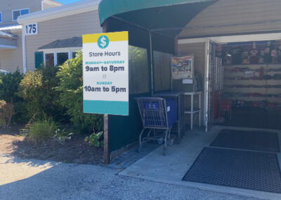 Tom's Discount exterior freestanding store hours aluminum sign blank mounted on an aluminum pole