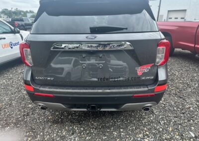 Rear view of a Ford Explorer Limited with unique Red Wing Shoes vehicle graphic design at Ace Ford in Woodbury, NJ