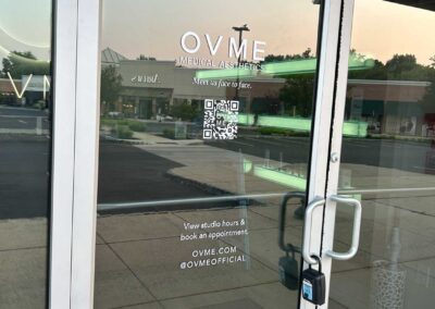 White gloss vinyl lettering applied to a glass door at a medical spa